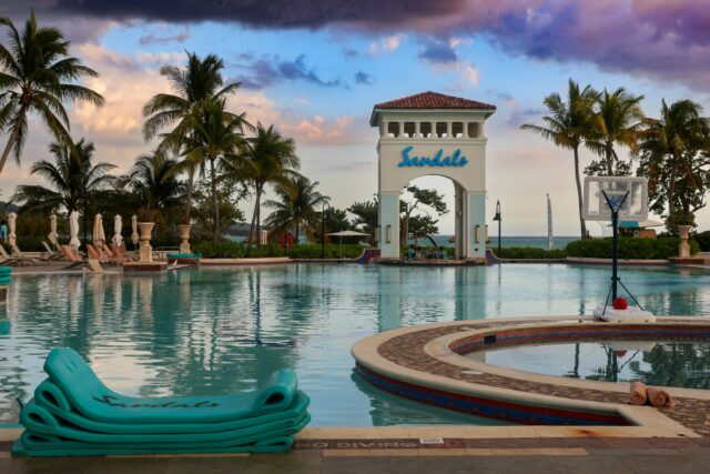 Large swimming pool in front of a clock tower