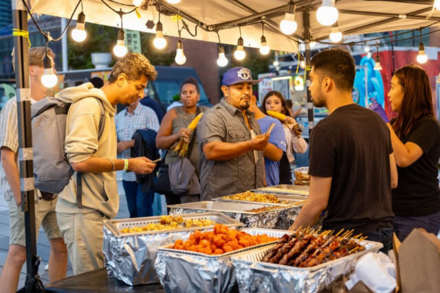 People buying street food at Toronto’s Underground Night Market
